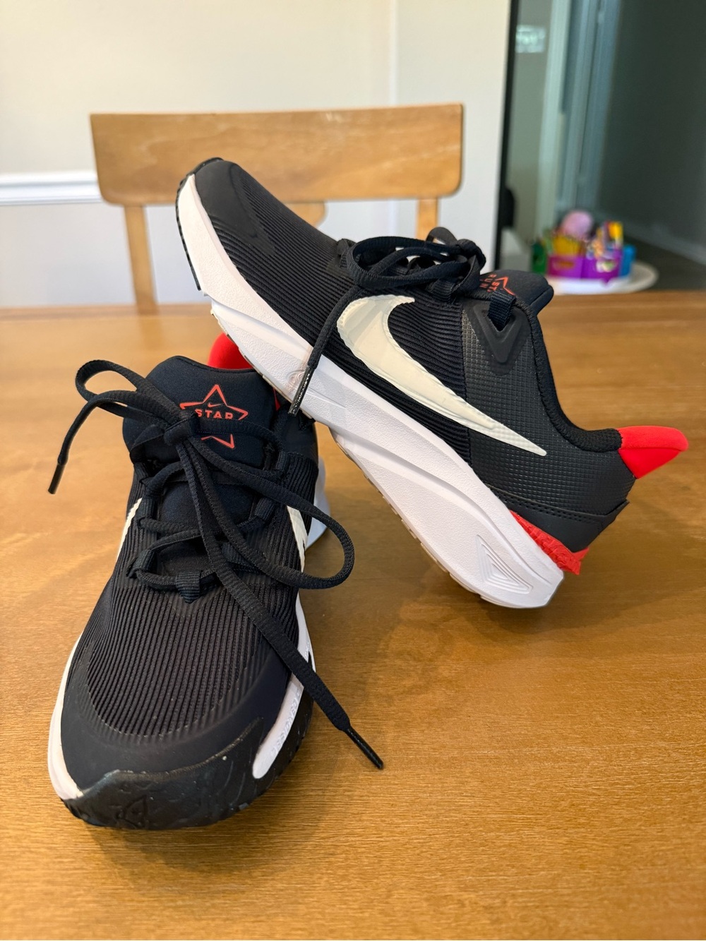 Nike Kids Black Sneakers with White Swoosh and Red Accents